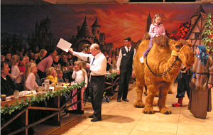 Offering members of the audience a camel ride at a concert